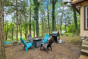 An outdoor seating area with Adirondack chairs, a fire pit, and a grill. - Lakefront Home on Old Hickory Lake (Old Hickory)