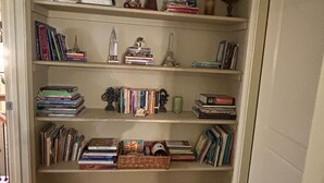 A bookshelf with books and decorative items. - FIFA READY! Spacious 8-bedroom Retreat in Stone Mountain (stone mountain)