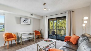 A modern living room with a sofa, armchairs, a coffee table, and a dining area. - Jamaica Bay 308B (Ocean City)