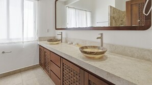A bathroom with two vessel sinks, a large mirror, and a wooden cabinet. - Two Bedroom Penthouse Palapa Ocean View (Puerto Escondido)