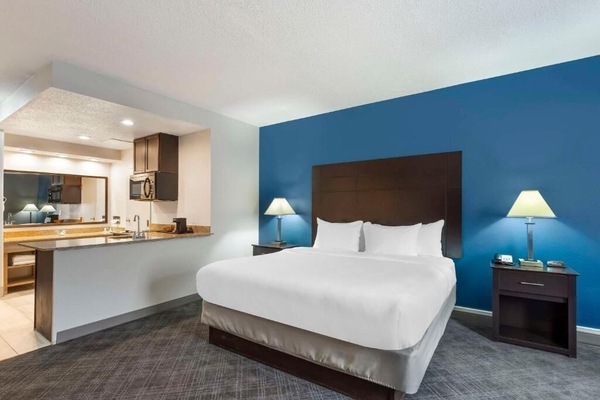 Drift off in a serene king room with calming colors.