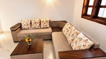 A modern living room with a sectional sofa, a coffee table, and a ceiling fan.