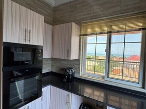 Private kitchen - Ayan Villas  luxurious One bedroom penthouse with a beach view! (Oshiyie)