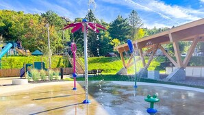A water play area with a slide, a climbing structure, and a bridge. - LAO LOFT 106 by Gestion ELITE (Mont-Tremblant)