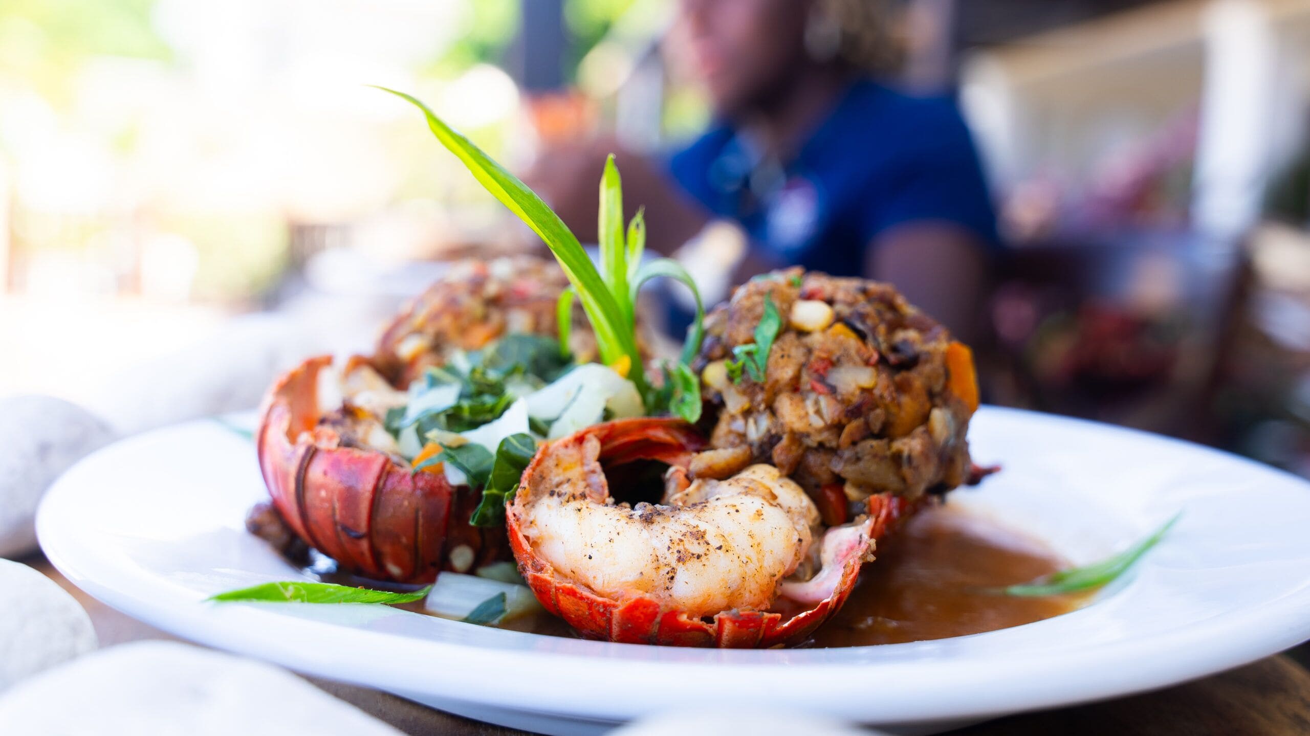 A lobster dish on a plate with a blurred background.