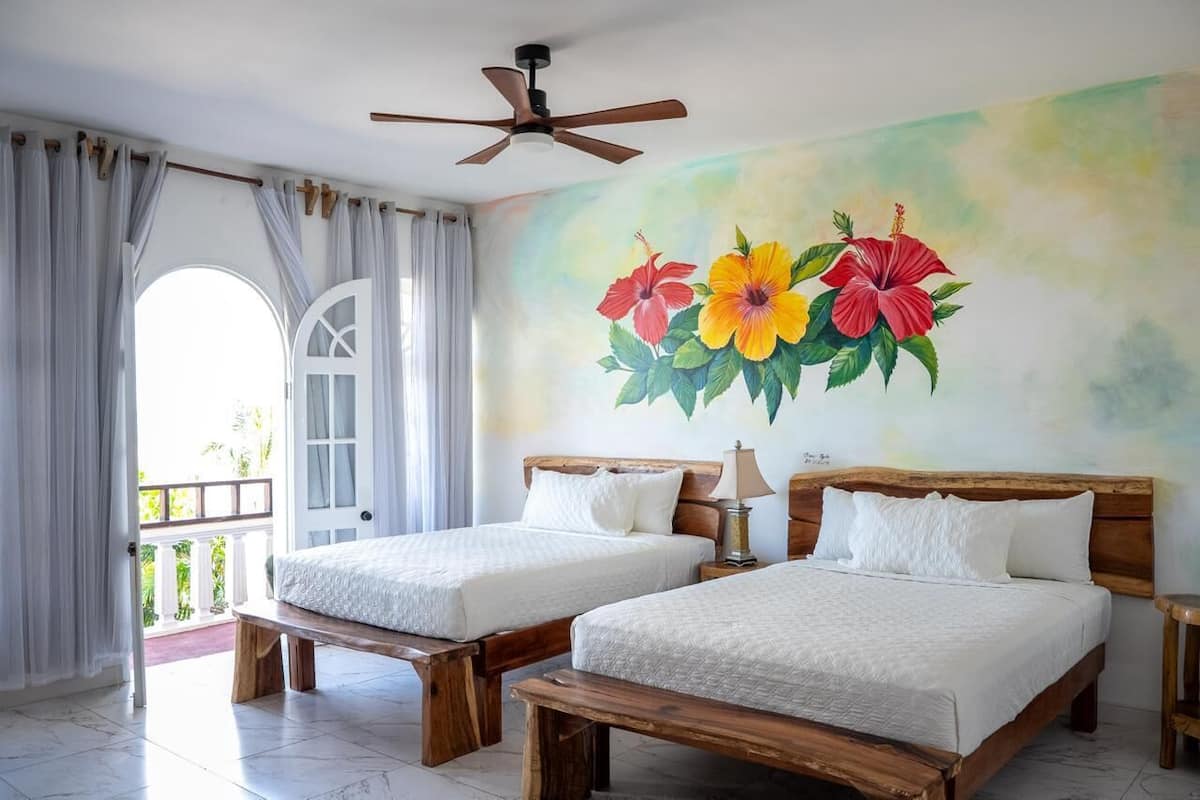 Standard Room, 2 Queen Beds, Garden View | In-room safe, desk, laptop workspace, blackout drapes