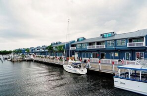 A waterfront hotel with a dock, a row of buildings, and a boat. - Waterfront Punta Gorda Isles Home • Dock • Kayaks • Sunset Views • Gulf Access (Punta Gorda)
