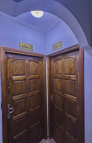 A set of wooden double doors with signs above them reading 'Atlas-2' and 'Atlas-1'. - Atlas 001 (Tangier)