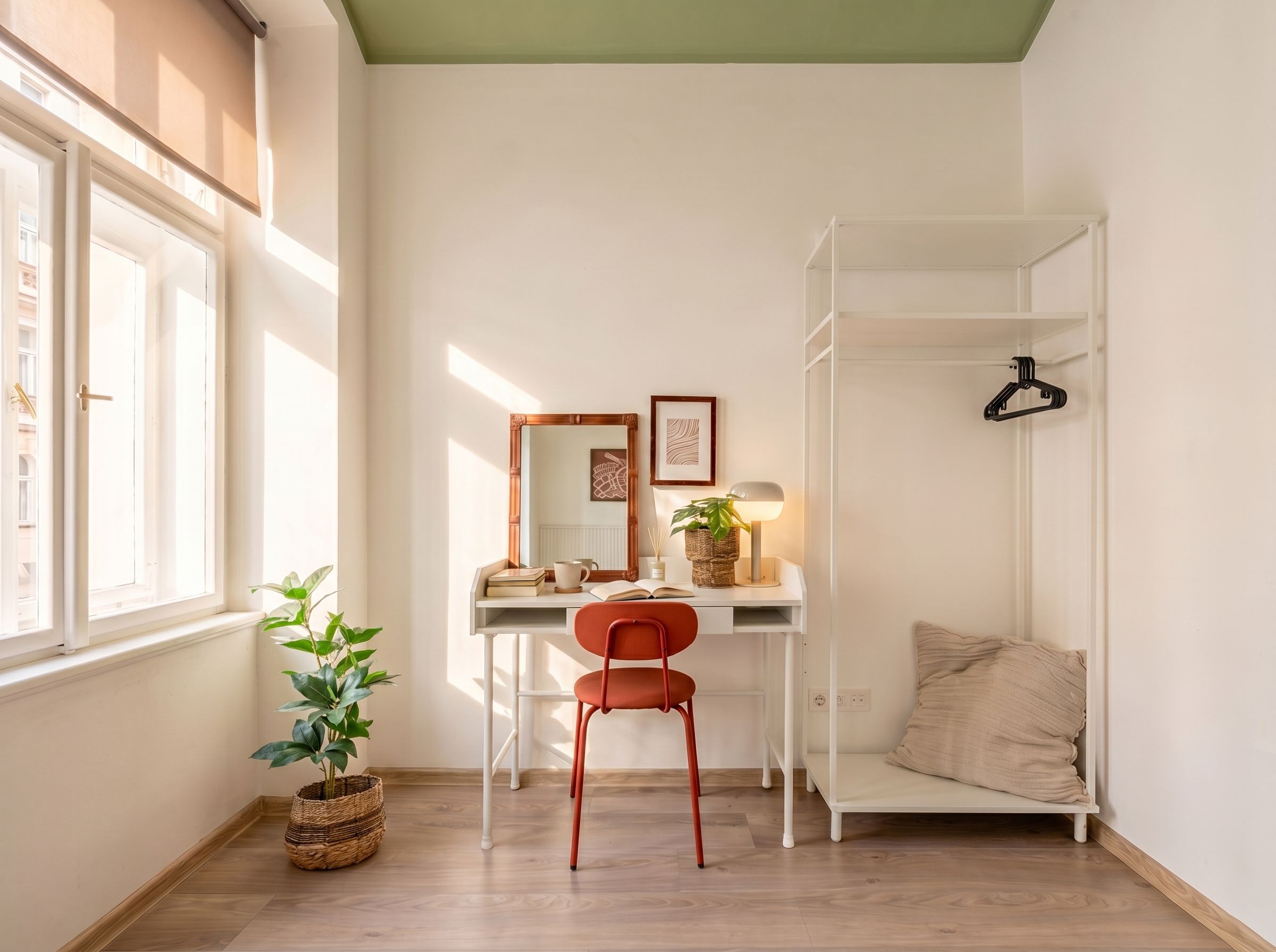 A room with a desk, chair, and a hanging shelf.