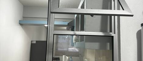 A kitchen with a window, a sink, and a faucet.