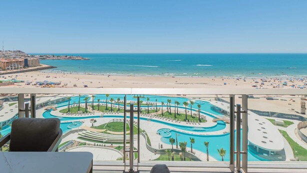 Ein Resort mit Poolbereich, Strand und Meerblick.