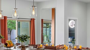 A breakfast setting with a fruit bowl, coffee cups, and orange juice on a counter. - Scottsdale-4BR Retreat-Pool, Fire Pit, Pool Table, Shuffle board, BBQ (Scottsdale)