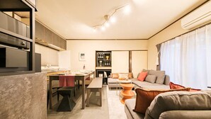 A modern interior with a kitchen, dining area, and living room.