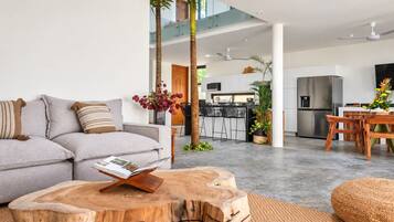 Living area with sofa and open kitchen behind