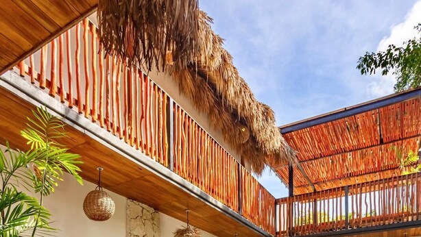 A poolside area with lounge chairs, a thatched roof, and potted plants. - Casa Veleta: Designer Villa with Pool & Jacuzzi (Tulum)