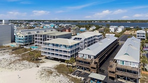 A coastal hotel with multiple buildings, a swimming pool, and a view of the ocean. - Beachfront 2BR Condo with Pool and Beach Access (Gulf Shores)