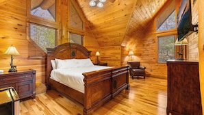 A wooden cabin bedroom with a four-poster bed, two windows, a ceiling fan, and a wooden dresser. - New Cabin! Family Fun - 6 BR - Smoky Mountains Views, Hot Tub, Arcades (Gatlinburg)