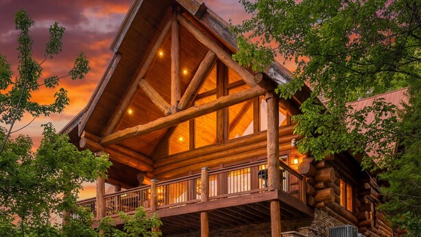 A log cabin with a fire pit and outdoor seating. - New Cabin! Family Fun - 6 BR - Smoky Mountains Views, Hot Tub, Arcades (Gatlinburg)