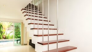A modern staircase with wooden steps and metal railings, leading to an upper floor. - 3-bedroom Pool Villa in lovely Tambon Kamala with cool AC (Tambon Kamala)