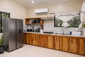 Eine moderne Küche mit Einbaukühlschrank, Mikrowelle und Kaffeemaschine.