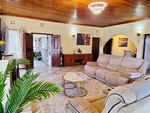 A living room with a sofa, a coffee table, and a potted plant. - Beautiful 4 bedroom home located in the heart of Naivasha town. (Naivasha)