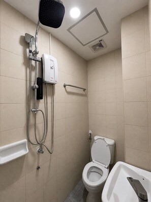 A small, modern bathroom with a toilet, bidet, and shower. - Dream Nest Patong Hotel Patong (Patong)