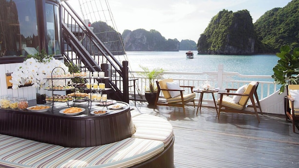 A deck with a buffet, lounge chairs, and a view of the sea. - LAN HA BAY  STAR CRUISE  (Tuan Chau)