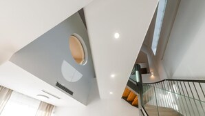 A modern interior with a staircase, a circular skylight, and a glass railing. - Chic Family Villa With Pool in Syvota (Igoumenitsa)