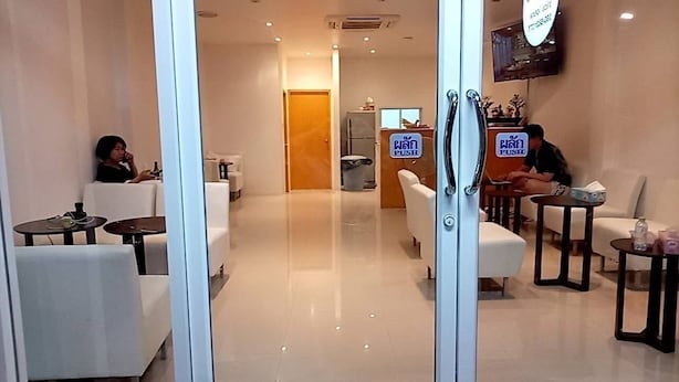 A hotel lobby with seating areas, a reception desk, and a visible 'PUSH' sign. - Rawai cozy hostel (Rawai)