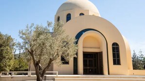 A church with a dome and a cross on top, surrounded by trees. - Luxury Boutique Apartment • 5-Minute Walk to the Beach • Athens Riviera (Vouliagmeni)