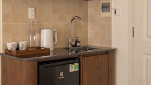 A compact kitchen with a microwave, coffee maker, and a dishwasher. - Saigon Maison 1988 Bui Vien Central (Ho Chi Minh City)