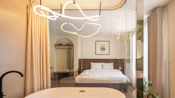 A modern bathroom with a freestanding bathtub, a shower, and a glass-enclosed bed area. - Saigon Maison 1988 Bui Vien Central (Ho Chi Minh City)