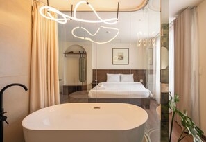 A modern bathroom with a freestanding bathtub, a shower, and a glass-enclosed bed area. - Saigon Maison 1988 Bui Vien Central (Ho Chi Minh City)
