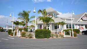 A beachfront building with a sign for Ron Jon's Surf Shop. - Cute, spacious 1-bedroom oceanfront condo with free WiFi, an outdoor pool, and an expansive balcony located midtown! (Ocean City)