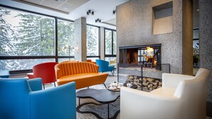 A modern interior with a fireplace, large windows, and contemporary furniture. - Stylish Alpine Base With Workspace (Araches-la-Frasse)