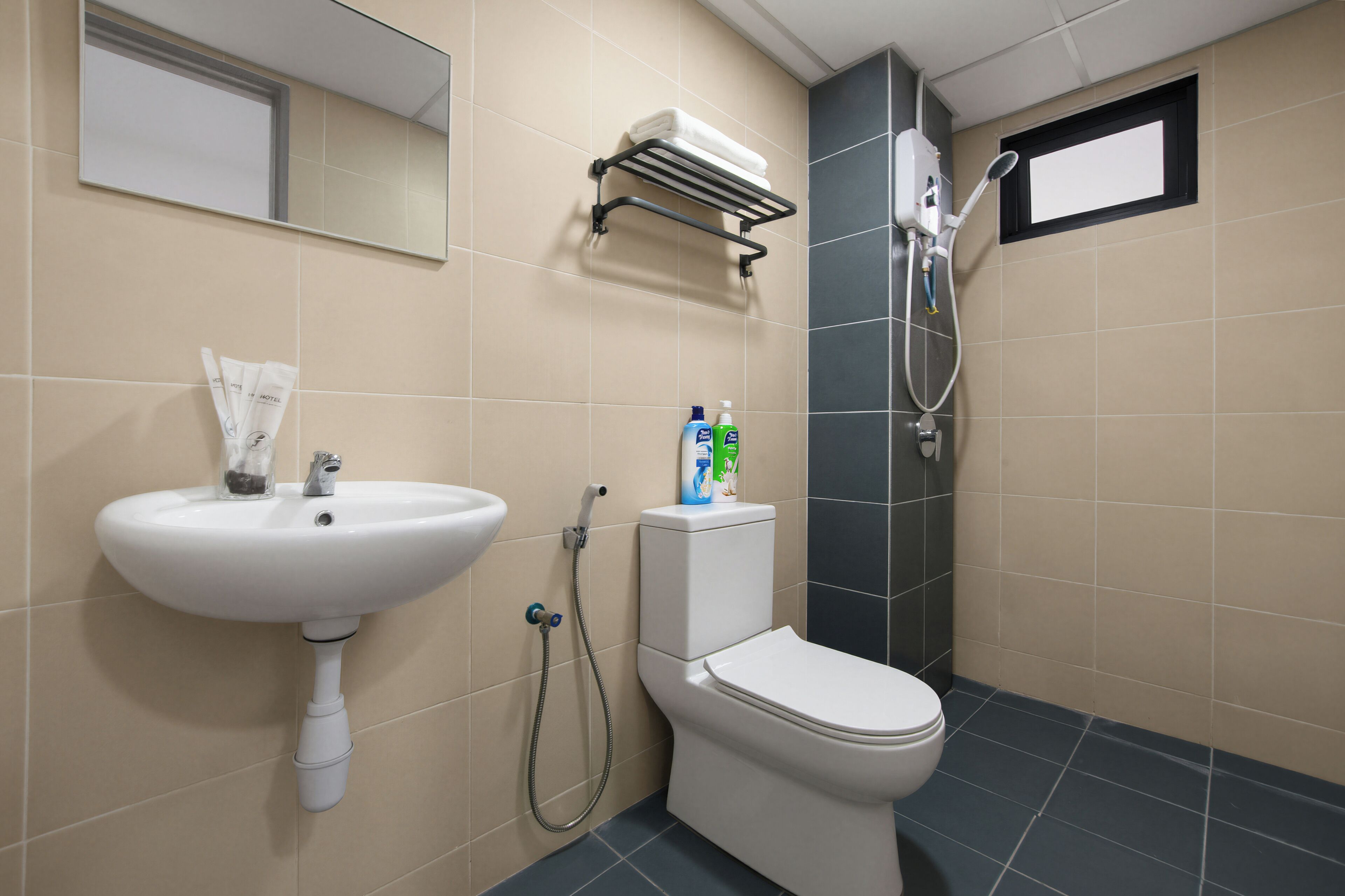 A bathroom with a sink, toilet, and shower.