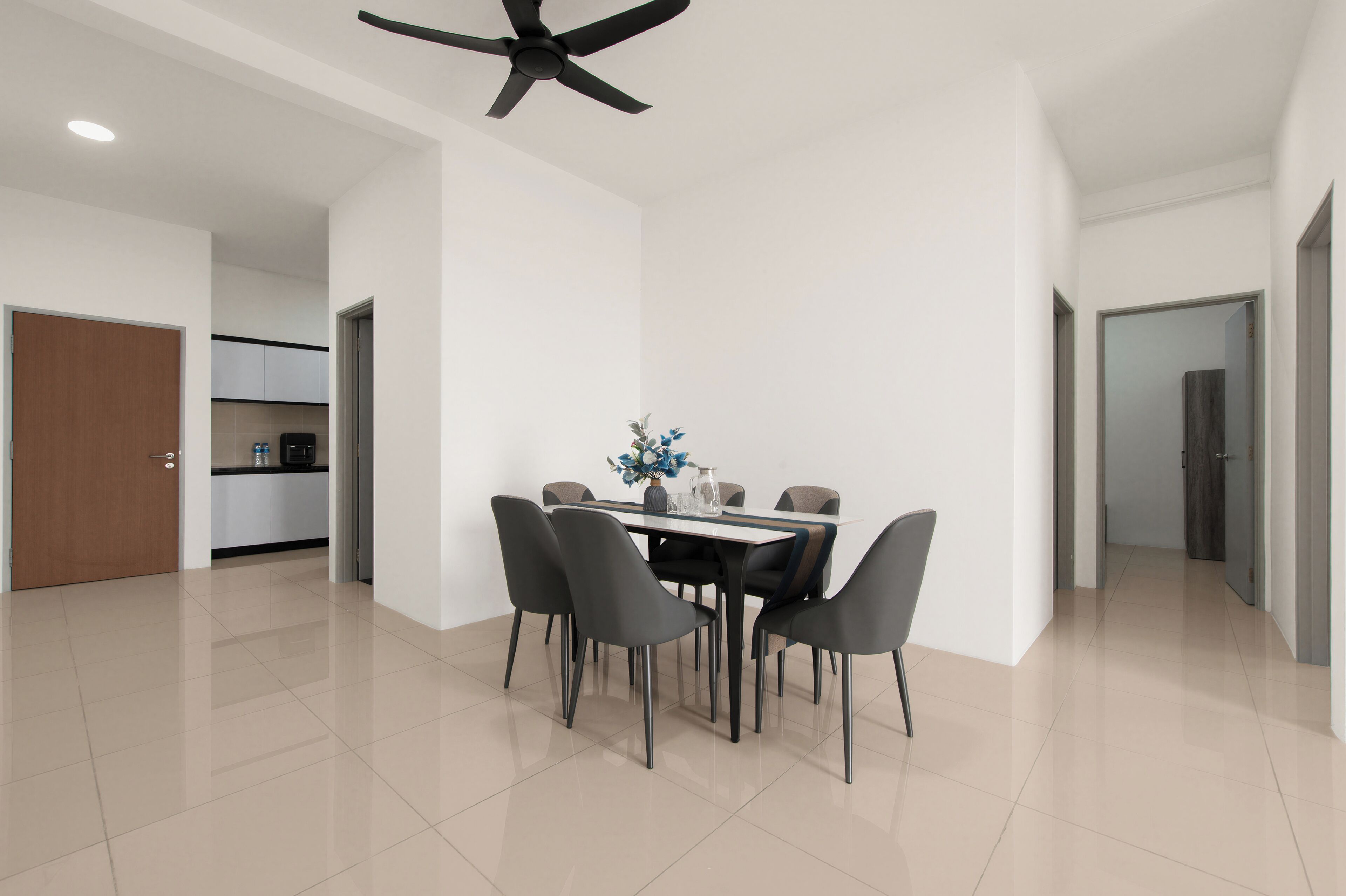 A modern dining area with a table, chairs, and a ceiling fan.