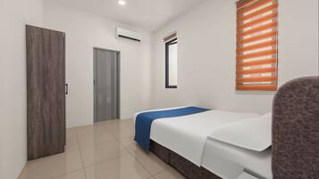 A hotel room with a bed, a wardrobe, an air conditioning unit, and a window with blinds.