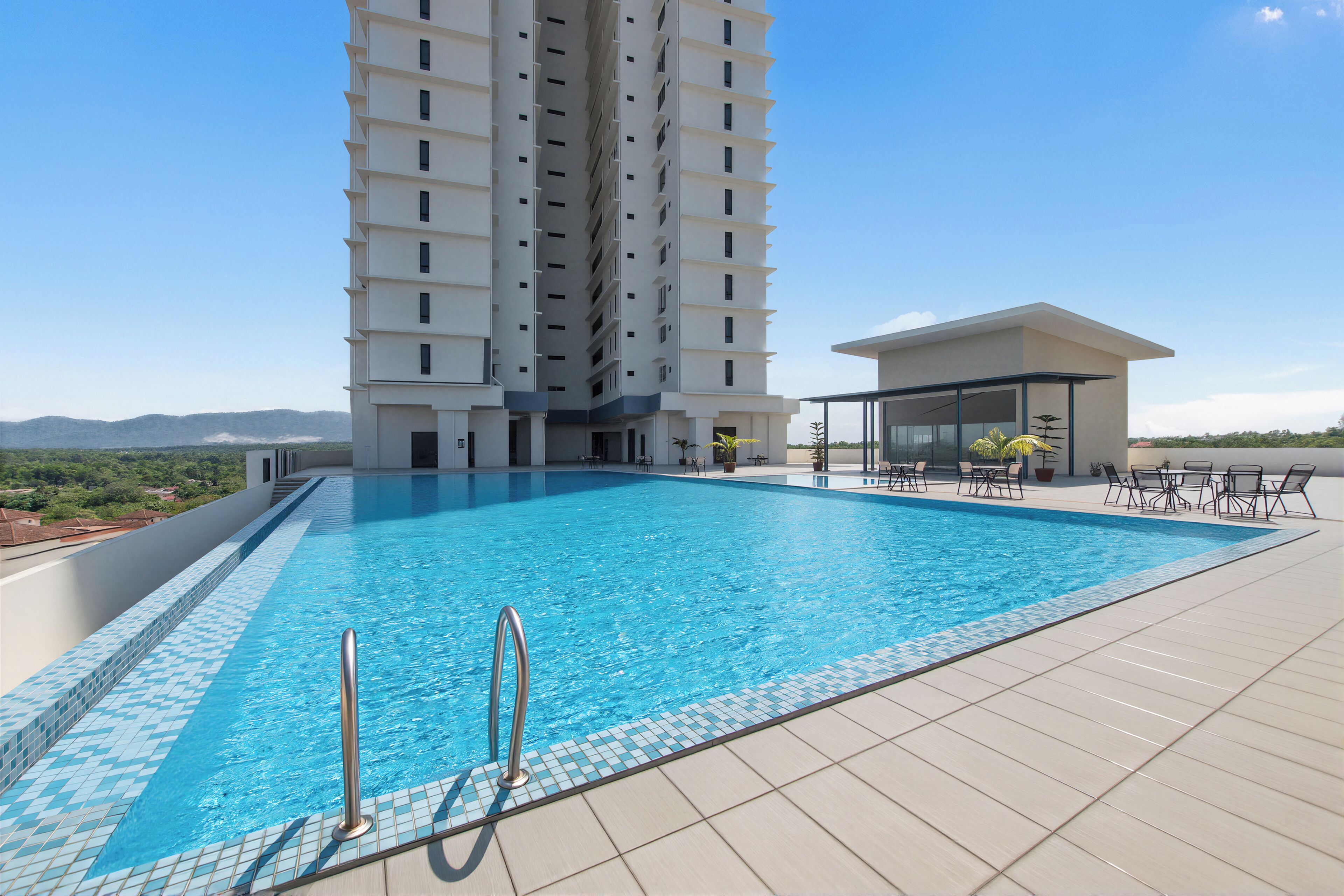 Una piscina con bordes de azulejos, una escalera de metal y un edificio de varios pisos al fondo.