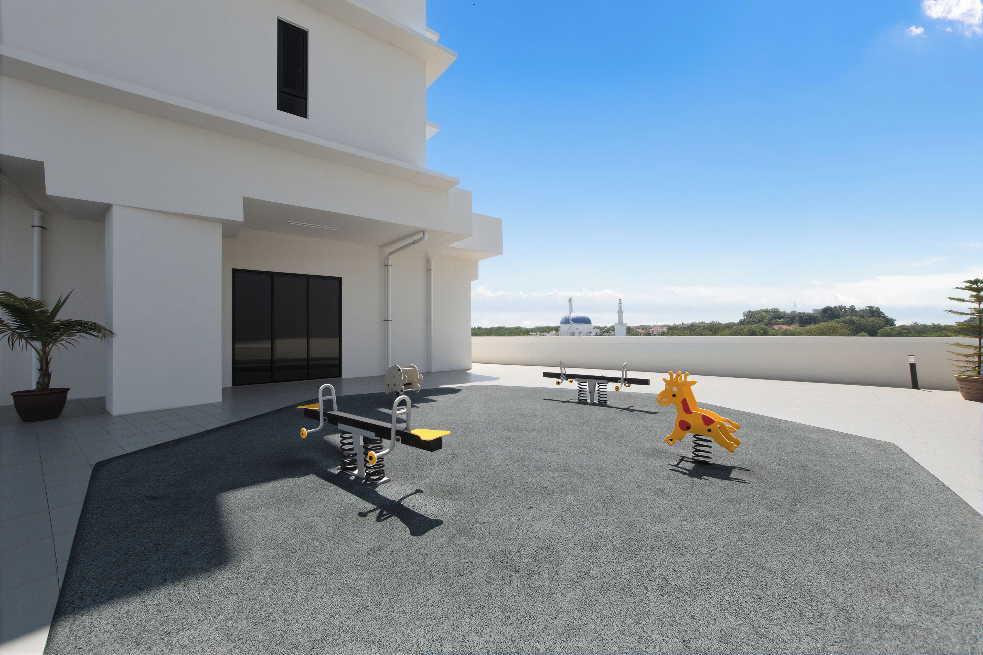 A rooftop with exercise equipment, a potted plant, and a building in the background.