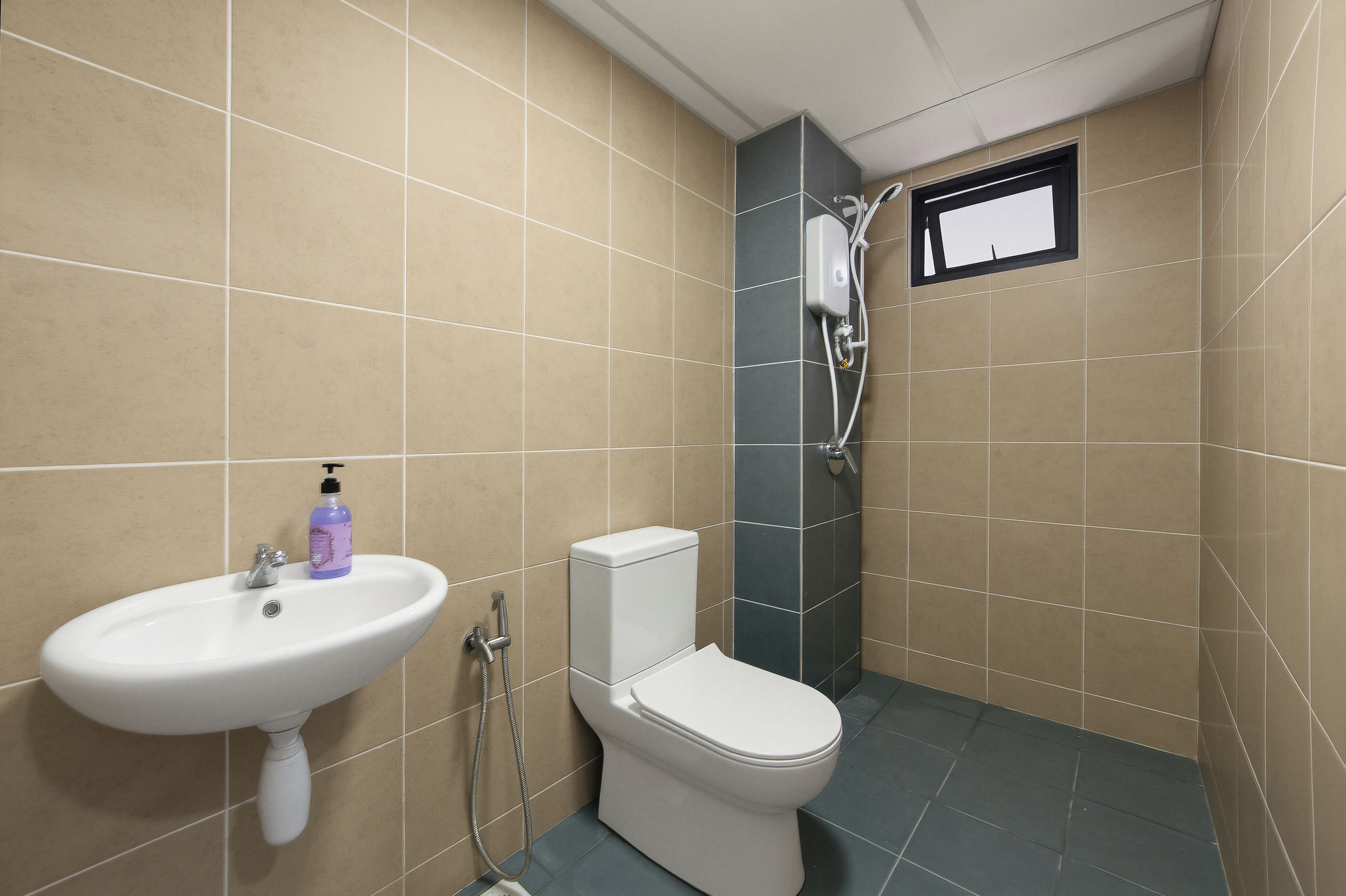 A bathroom with a sink, toilet, and shower.