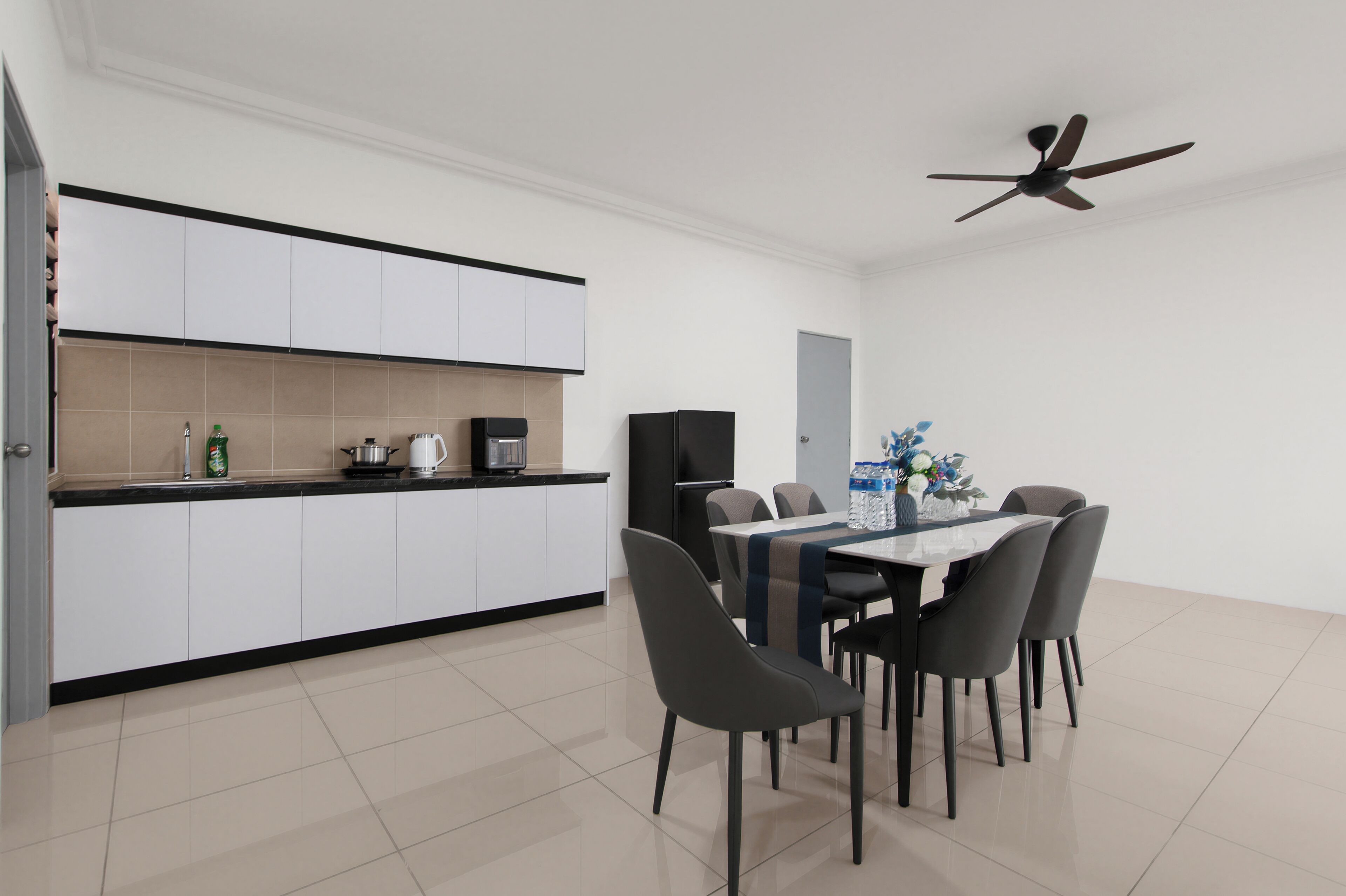 A modern kitchen with white cabinets, a dining area with a table and chairs, and a ceiling fan.