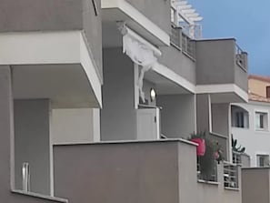A multi-story building with balconies, a flat roof, and a clear sky. - Charming Accommodation in Castelsardo (Castelsardo)