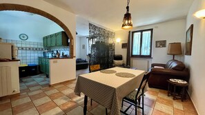 A compact living space with a dining area, kitchen, and seating area. - Entire cottage fully furnished, in the green heart of Umbria region (Umbria)
