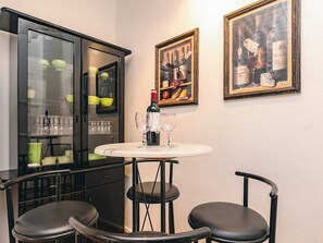 A dining area with a table, chairs, a cabinet with glass doors, and framed artwork on the wall. - 6 Person Holiday Home in Brovst (Brovst)