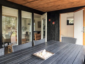 A dining area with a large table, chairs, and a tray with food. - 4 Star Holiday Home in Lokken (Lokken)
