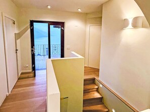 A staircase leading to a balcony with a view of the sea. - Villa Chiara by Interhome (Brissago)