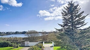 A pathway leading to a modern building with a view of a bridge and water. - Maison de la Ria by Interhome (Plouhinec Morbihan)