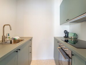 A compact kitchen with a sink, a coffee maker, a toaster, and a microwave. - Studio 4.3 with balcony & airco by Interhome (Bredene)