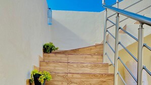 A set of wooden stairs with metal railings, leading to a higher level. - Villa sabrina gold (Djerba Midun)